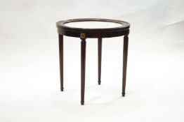A French circular mahogany occasional table, the top inset with marble,