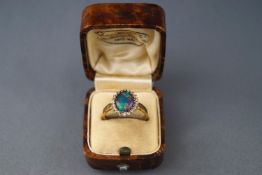 An opal-doublet and paste oval cluster ring, set in gilt stamped '925, size P, 2.