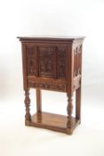 A 17th century style carved oak cabinet, heavily carved with mythical beasts,