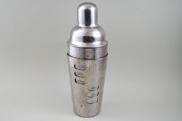 A plated cocktail shaker, the body revolving to display the recipes’ and measures,