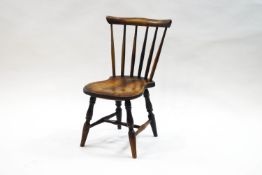 A country child's stick back chair with shaped elm seat,