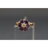 A gold, amethyst and diamond cluster ring, centred with a round brilliant diamond approx. 0.