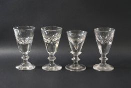 Four 19th century deceptive toasting glasses, each with a conical bowl,