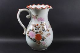 A Japanese porcelain jug with a crimped rim and painted with fish and flowers,