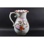 A Japanese porcelain jug with a crimped rim and painted with fish and flowers,