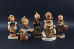 A collection of five Goebel earthenware figures of children,