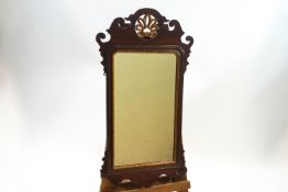A George III style mahogany wall mirror with gold painted pierced shell pattern crest,