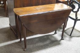 A George II mahogany oval drop leaf table on turned tapering legs and pad feet,