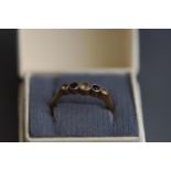 An early 20th century blue and colourless paste graduated five stone ring, stamped '18ct & Plat',