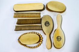 A collection of late Victorian ivory backed brushes and an ivory beaded necklace