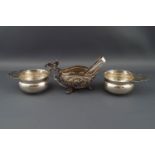 Two silver small quaiches, each with a floral scroll pierced flat handle,