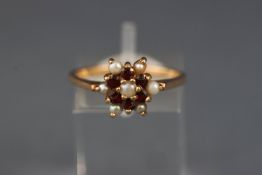 A 9ct gold, garnet and half-cultured pearl cluster ring, London 1973, size P, 2.