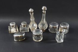 A set of five Victorian cut glass dressing case jars with silver covers, London 1843,