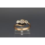 A 9ct gold and small diamond three stone cross-over ring,