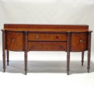 A late 19th century Scottish mahogany sideboard, the central drawer flanked by bow fronted drawers,