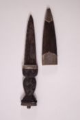 A Scottish sgian dhu, the ebony grip with silver mounts (unmarked) and leather sheath, 15.