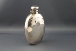 An early 20th century silver oval 6 3/4oz hip flask with a hinged twist cover,