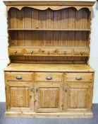 A Victorian pine dresser, the plate rack with two shelves and five small drawers,