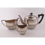 A plated oval part fluted three piece tea service in Queen Anne style.
