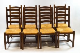A set of eight 20th century ladderback dining chairs with rush seats