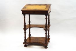 A Victorian walnut davenport on turned supports, with undertier shelf,