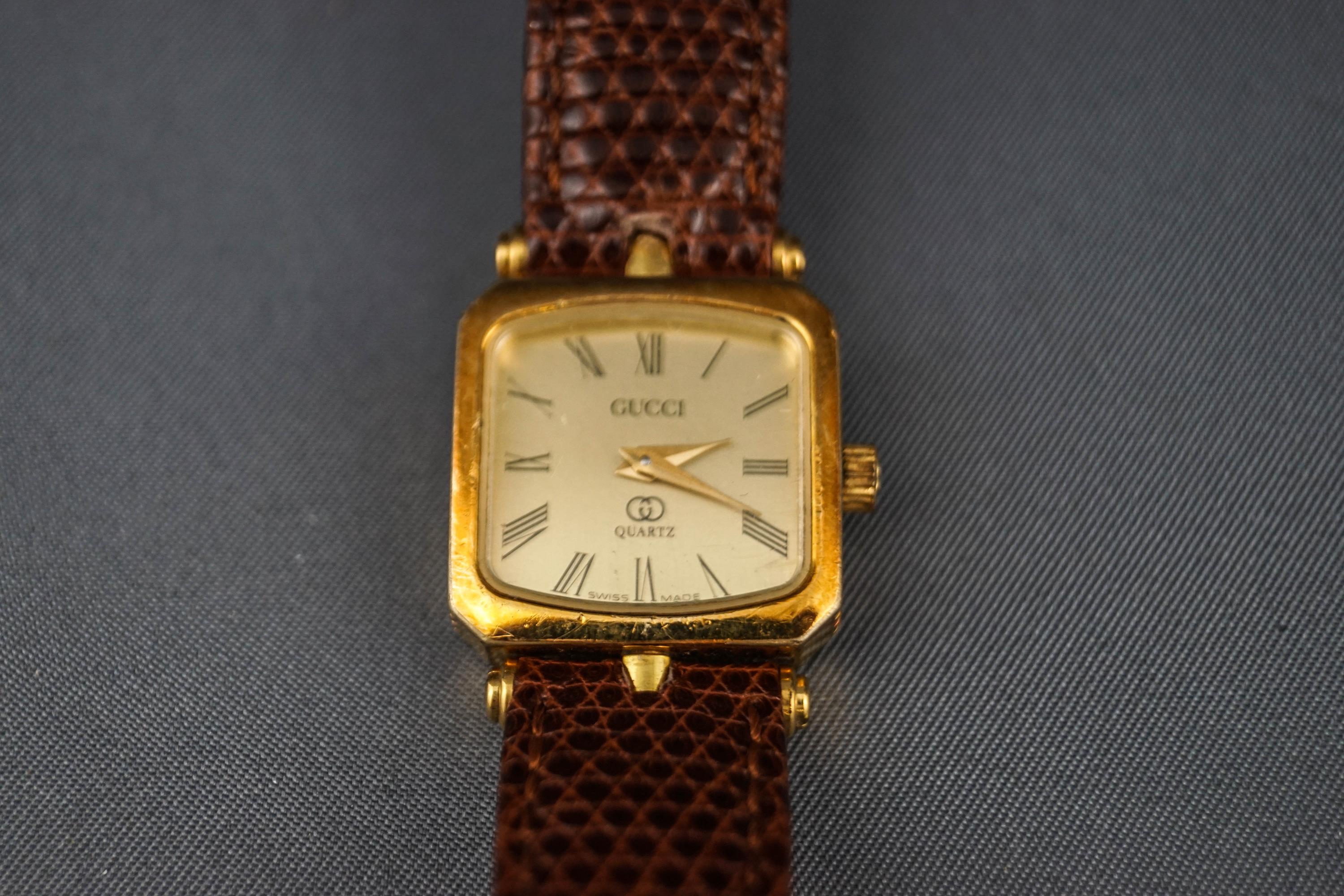 A Gucci quartz, a lady's gold plated oblong wrist watch,