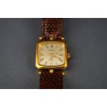 A Gucci quartz, a lady's gold plated oblong wrist watch,