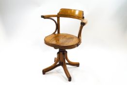 An office swivel chair with bentwood arm supports