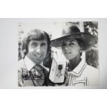 A signed photograph of Jackie Stewart receiving his OBE,