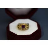 A synthetic ruby and diamond ring, indistinct marks, the square cut stone enclosed by single cuts,