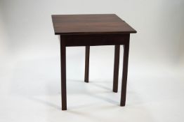 A 19th century mahogany fold over tea table with chamfered legs,