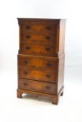 A reproduction walnut chest on chest of six drawers, the upper half with canted corners,