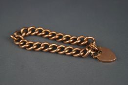 An early 20th century rose gold hollow curb bracelet, stamped '9', on a padlock clasp stamped '9c',