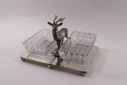 A EPNS stand modelled with a stag between two pressed glass nut dishes,