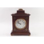 An early 20th century mahogany table clock, each corner inlaid with brass Gothic style symbols, 25.