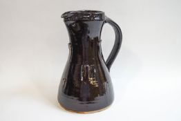 Jeremy Leach (b1941), a Lowerdown pottery stoneware jug with raised decoration and deep brown glaze,