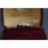 An 18ct gold and diamond three stone ring, the graduated round brilliants approx. 0.