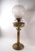 A Victorian brass Corinthian column oil lamp, with funnel and engraved globe shade,