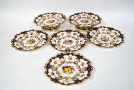A Royal Worcester hand painted part dessert service, decorated with roses and signed by E Phillips,