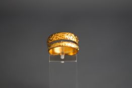 Two gold rings, comprising; a 22ct gold floral engraved wedding band,