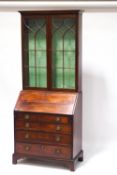 An early 19th century mahogany bureau bookcase,