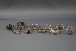 Ten various silver or white metal rings including a mystic quartz solitaire ring,