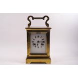 A large brass carriage clock, eight day movement, striking on a gong, with winding key, 26cm high,