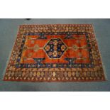 A 20th century Middle Eastern rug with central medallion within four alternating borders of