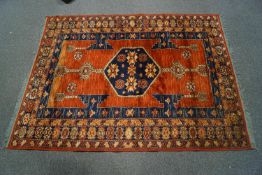 A 20th century Middle Eastern rug with central medallion within four alternating borders of