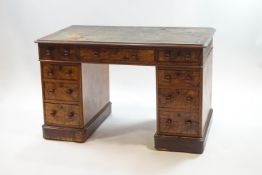A Victorian walnut pedestal desk with an arrangement of nine drawers with turned handles,