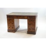 A Victorian walnut pedestal desk with an arrangement of nine drawers with turned handles,