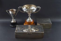 A silver two handled trophy cup, inscribed, Birmingham 1932, 147 grams on a wooden plinth,