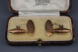 A pair of early 20th century gold cuff links,