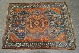 A small Middle Eastern rug, the central field with stylised animal and geometric motifs,